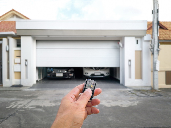 Hand holding the remote to open the sliding door.Remote control door.Electrical door.Automatic door.