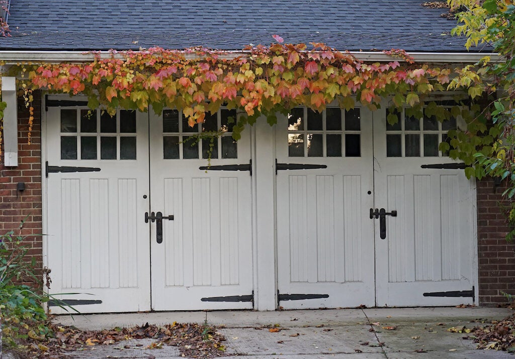 Garage with old style side hinged wooden doors